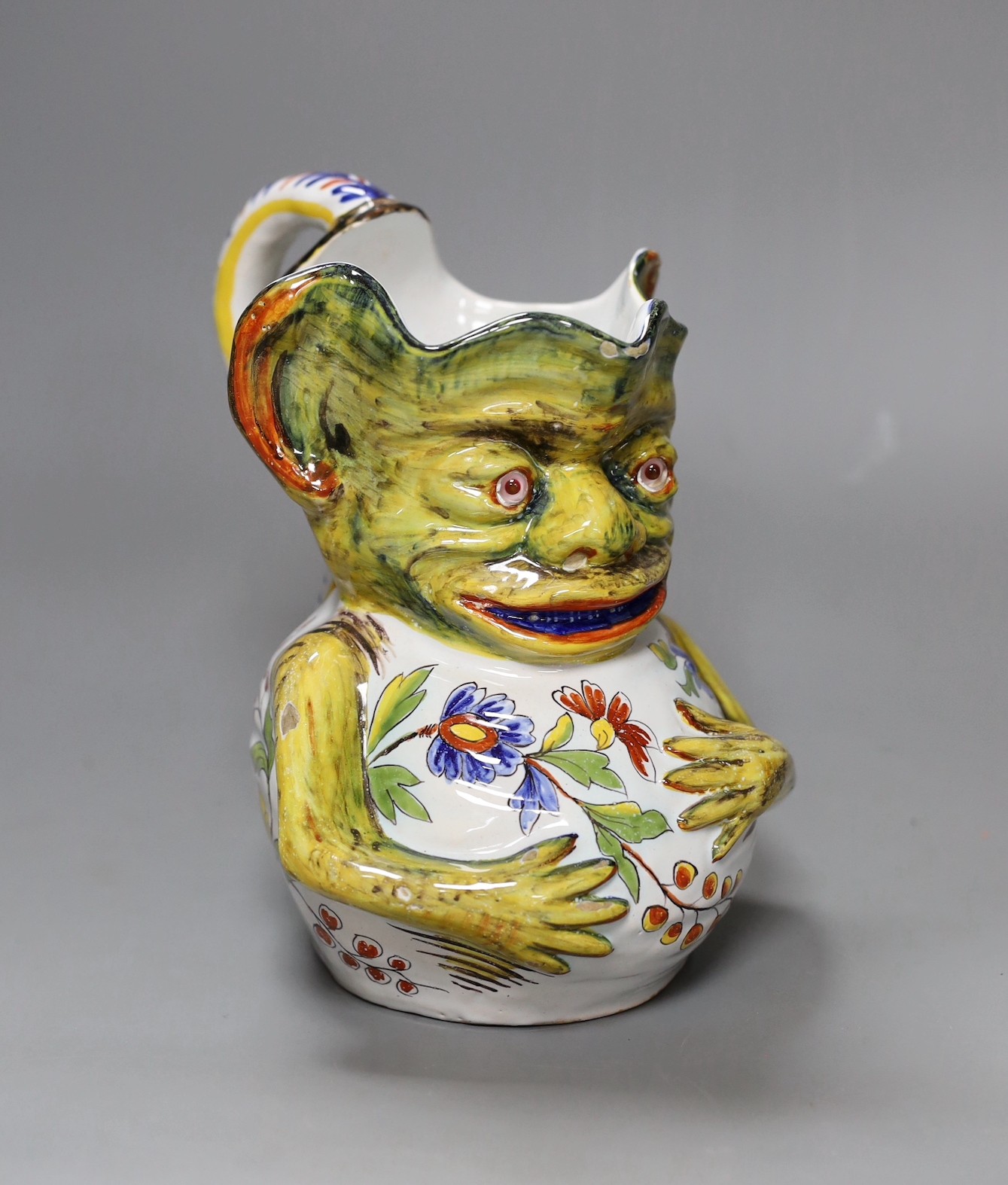 A Rouen faience grotesque jug, 19.5 high